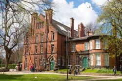 Exterior view of Lyddon Hall showing a four storey brick-built Victorian building on the University of Leeds campus