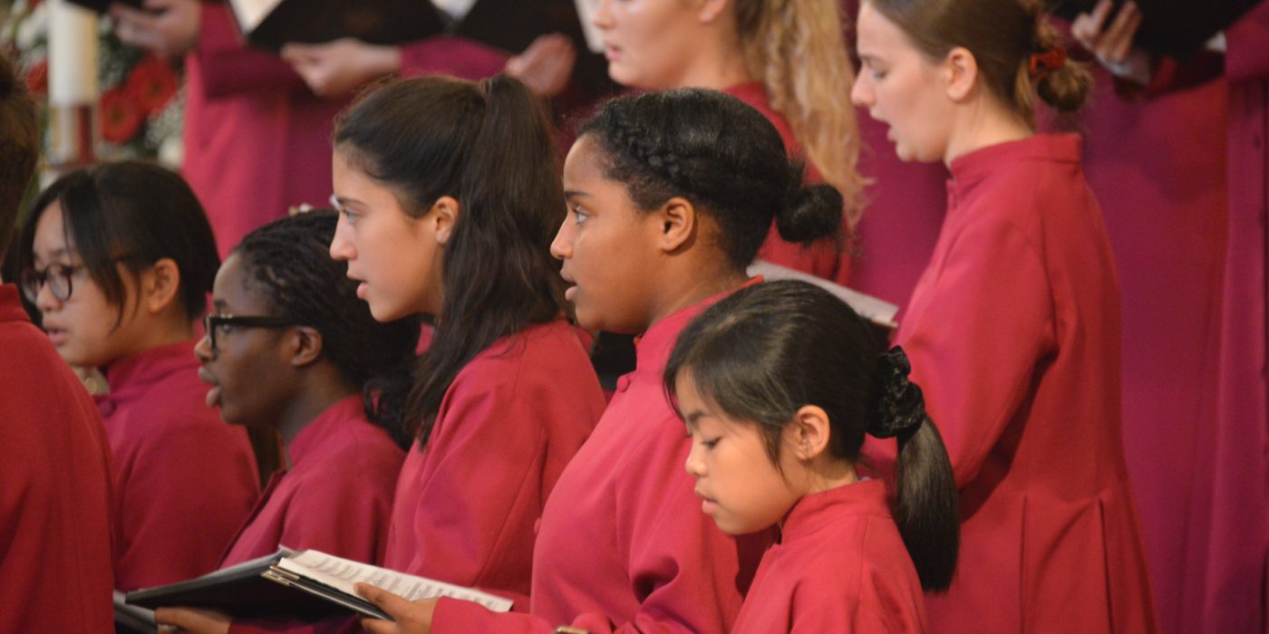 Senior girls choir of Leeds Cathedral holding music