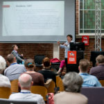 A speaker at IMC 2019.