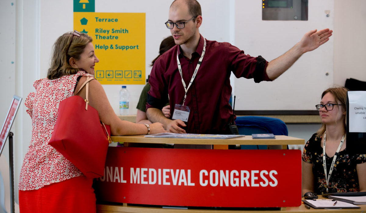 A delegate receiving information at the helpdesk at IMC 2019.
