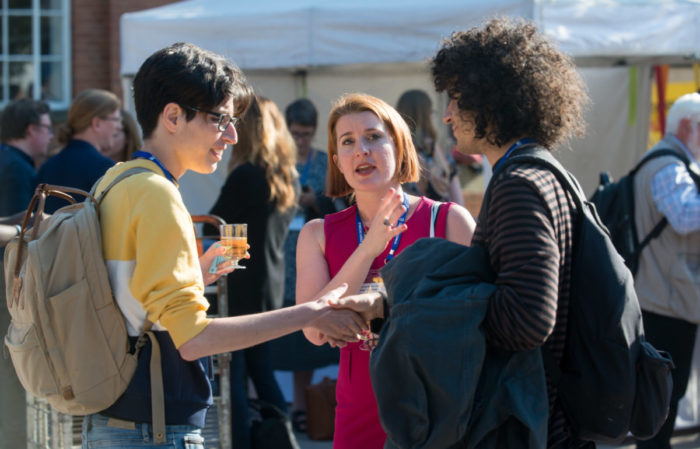 Delegates socialise on the crowded University Square during the outdoor reception at IMC 2019.