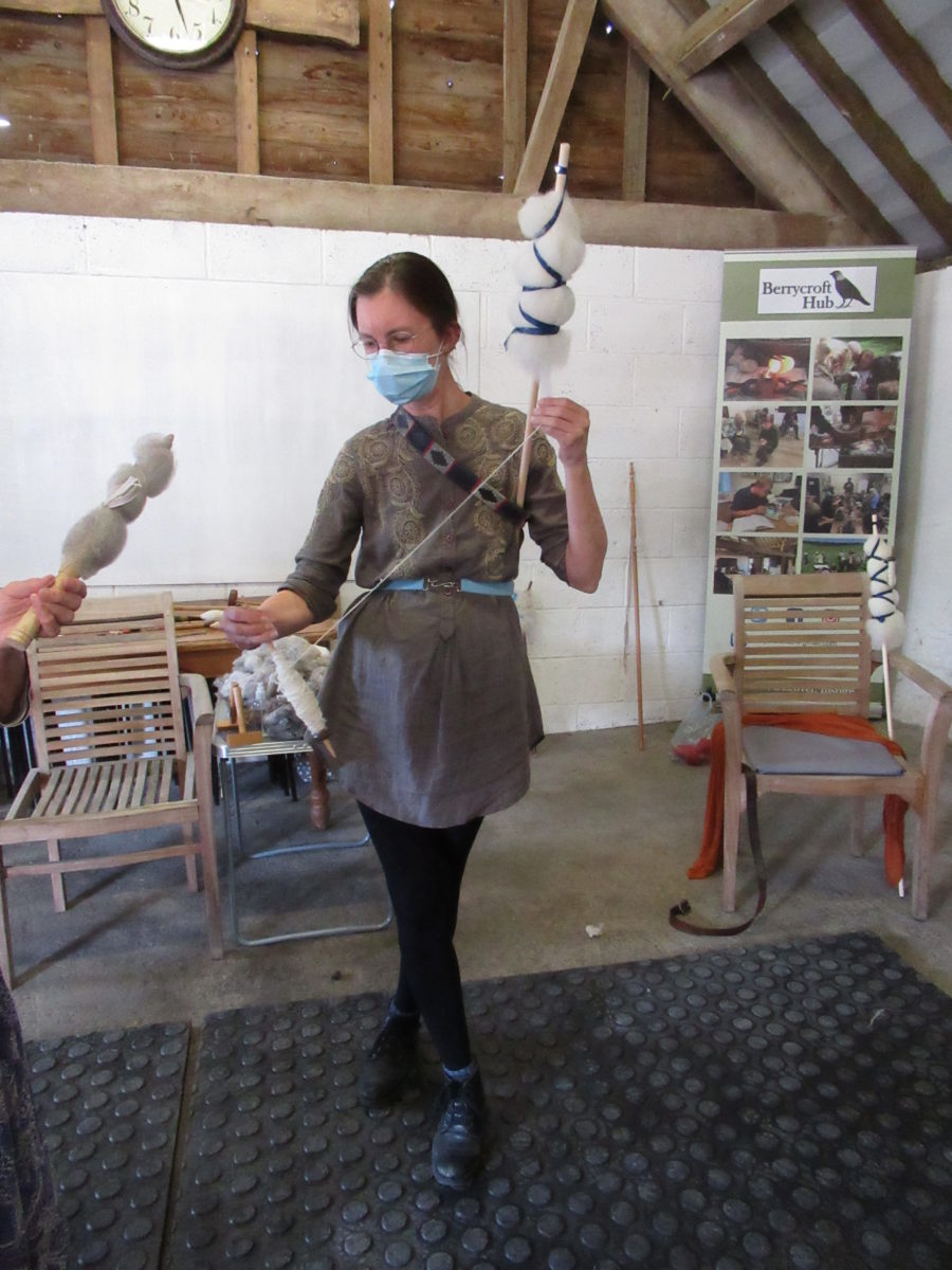 The instructor is stood wearing a mask and demonstrating spinning tehnique.