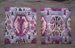 A closeup image of German brick-stiching. Two panels of purple, lilac and white stitching on a grey background. 