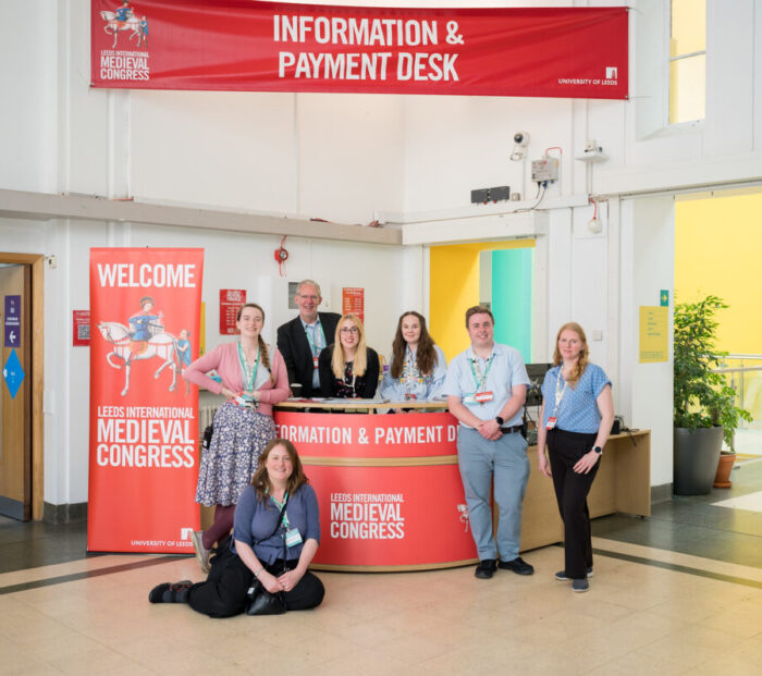 The IMC Team pose in front of the Information & Payments Desk in the Refectory Foyer