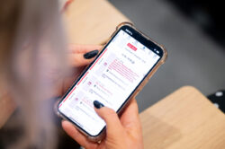 A delegate looking at the Virtual Platform on their phone